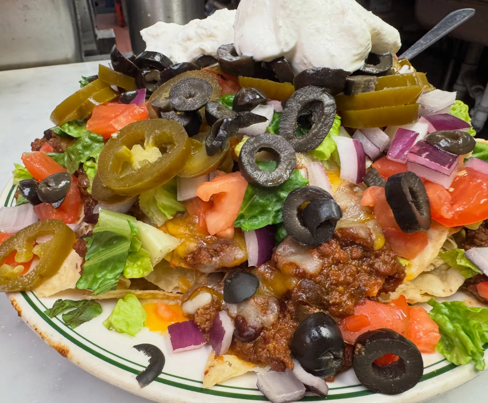 A Nacho Supreme at the Minisink Hotel — chips, chili, cheddar, lettuce, tomato, onion, jalapenos, olives and sour cream